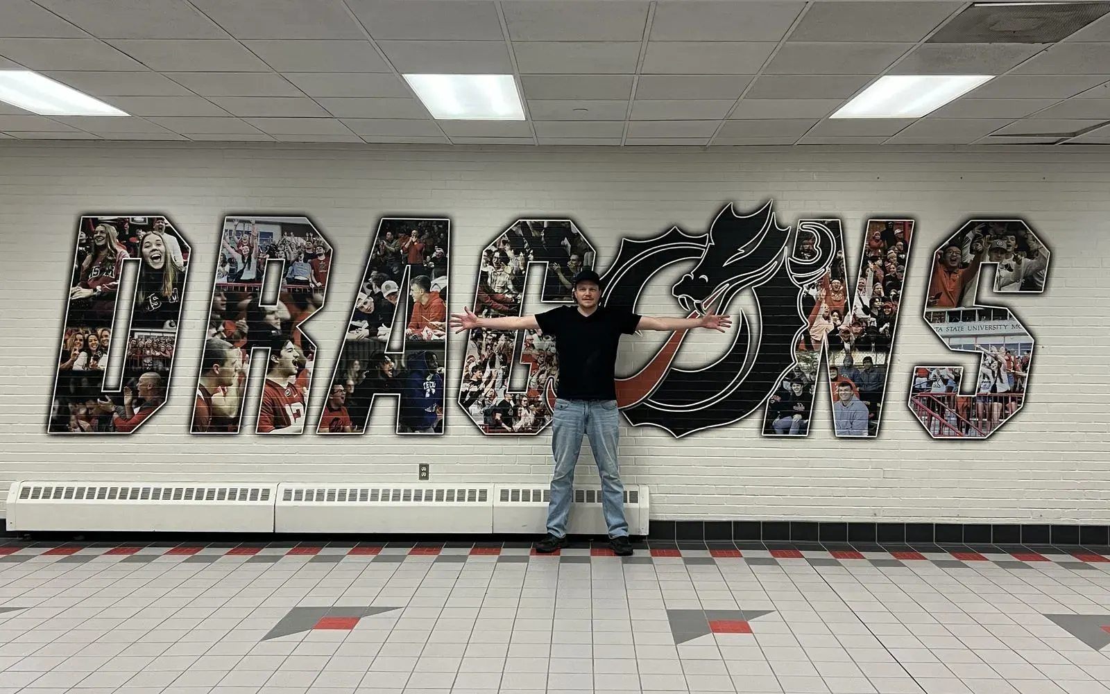 A school gym wall printed with the Dragons team name